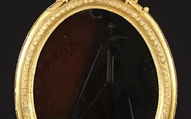 A 19th Century Gilt Framed Oval Wall Mirror. The top surmounted by a crest of scrolling acanthus, 31