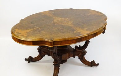 A 19thC burr walnut centre table with a moulded top above fo...