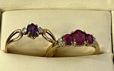 A 9ct gold dress ring set three rubies and four small diamon...