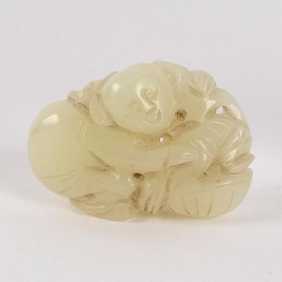 A Chinese pale celadon jade carving of a boy with a