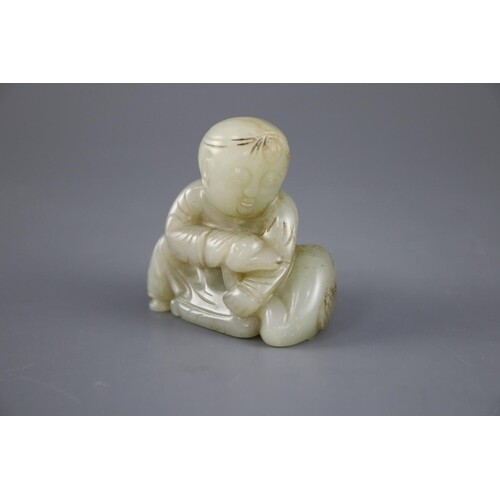 A Chinese pale celadon jade group of a seated boy and a duck...