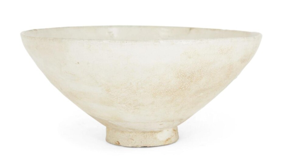 A Chinese stoneware Cizhou 'Juluxian' bowl, Song dynasty, circa 1100, the deep rounded sides rising from a short slightly-flaring foot, covered in a white glaze suffused with russet-coloured craquelure, 19cm diameter Note: According to historical...