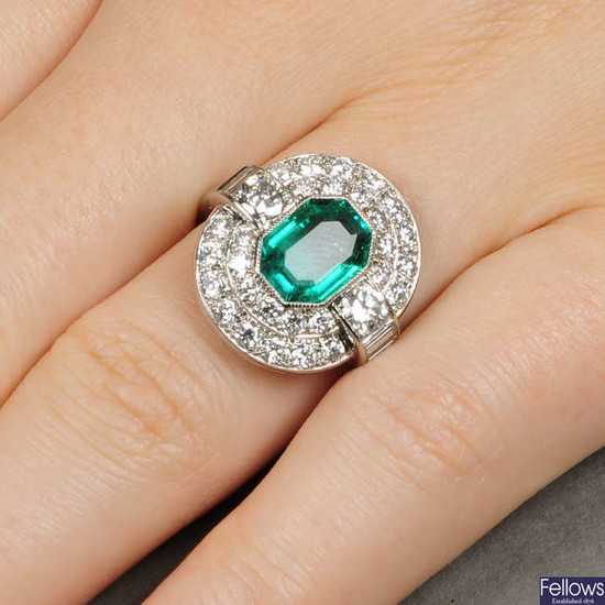 A Colombian emerald and diamond cluster ring.With