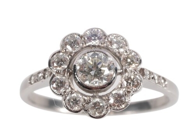 A DIAMOND DAISY CLUSTER RING c.0.80ct total weight, on a pl...