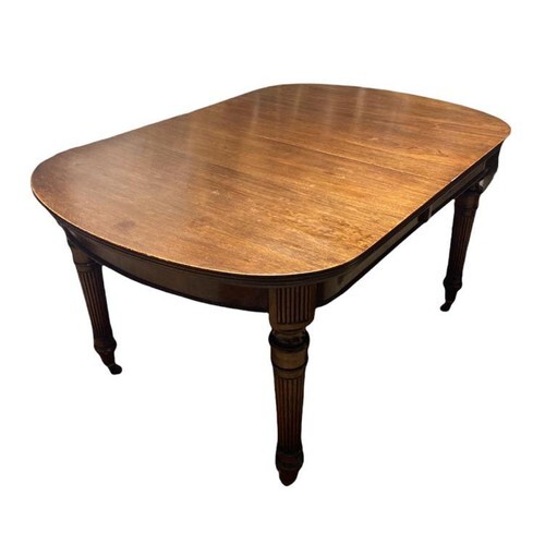 A LATE 19TH CENTURY MAHOGANY EXTENDING DINING TABLE, with tw...