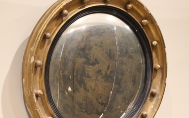 A Regency style giltwood and gesso convex wall mirror, late ...