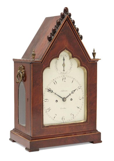 A Victorian Gothic style mahogany and boxwood line inlaid twin fusee mantel clock, late 19th century, the Gothic style case with shaped cresting and twin brass urn finials, on plinth base with bracket feet, having twin ring handles and glass panels...