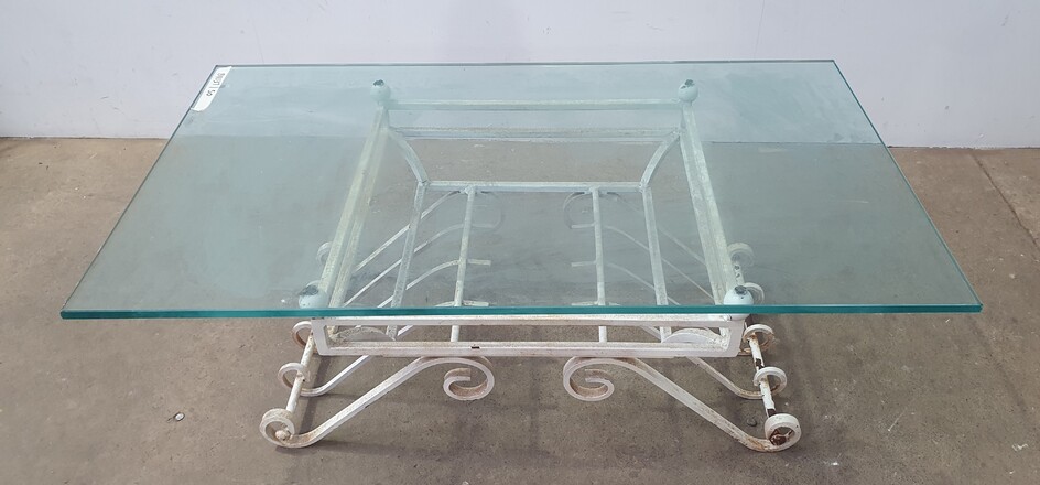 A WROUGHT IRON BASED GLASS TOP COFFEE TABLE