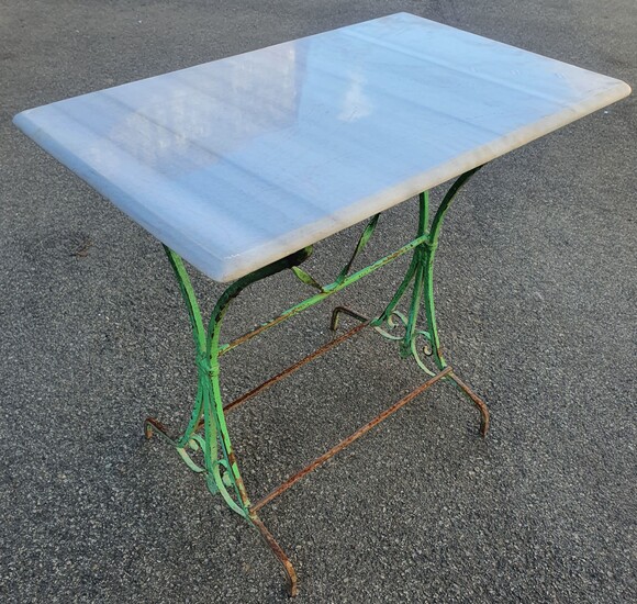 A WROUGHT IRON BASED MARBLE TOP TABLE
