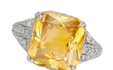 A YELLOW SAPPHIRE AND DIAMOND RING set with an oct ...