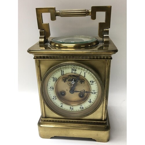 A brass cased carriage clock inset with barometer.