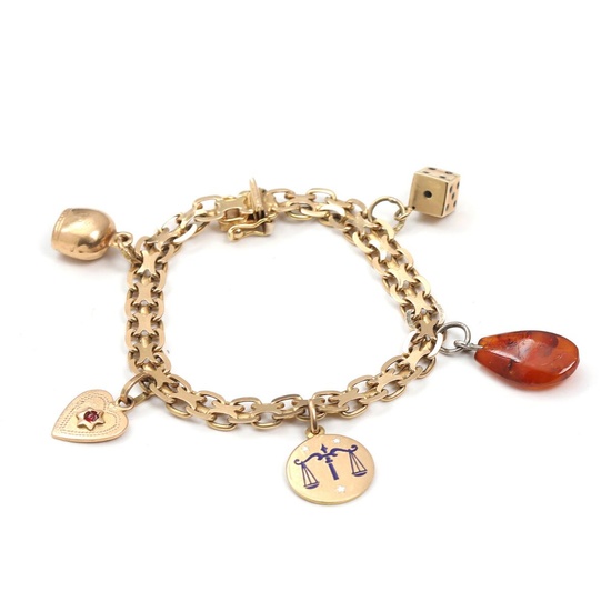 A charm bracelet of 18k gold with four charms of 14k and...