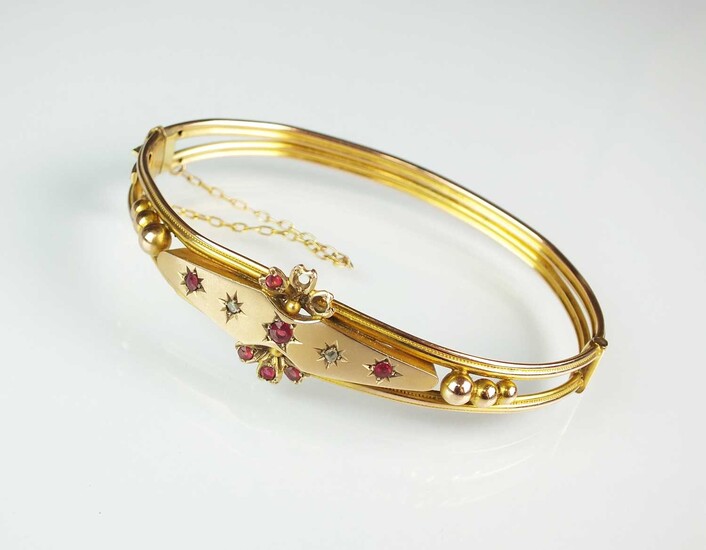 A garnet topped doublet and rose cut diamond hinged bangle