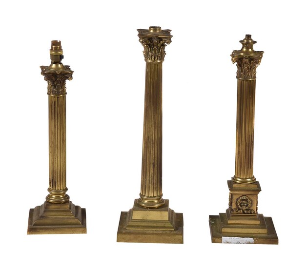A group of three gilt brass columnar oil lamp bases