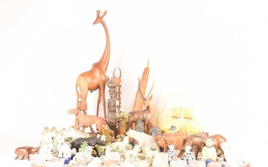 A large collection of decorative art figures comprising a large group of safari animals, a wooden go