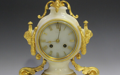 A late 19th century French ormolu and white onyx mantel clock with eight day movement striking on a