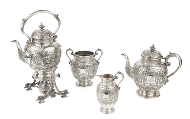 A late Victorian Scottish silver four piece tea service, embossed...
