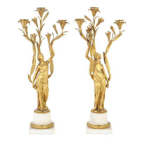 A pair of 19th century French gilt bronze and white marble figural three light candelabra