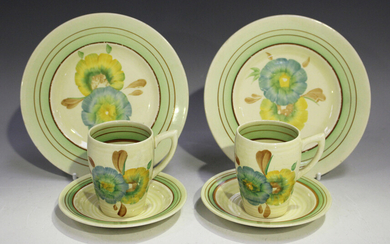 A pair of Clarice Cliff Honeydew pattern trios, 1930s/40s, comprising coffee cup, saucer and side pl