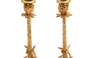 A pair of circa 1900 gilt bronze candlestick holders, cast with lions,...