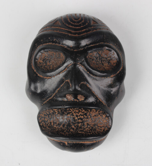 A pre-Columbian Taino style carved black stone zemi mask, Dominican Republic, probably 1000-1500 AD
