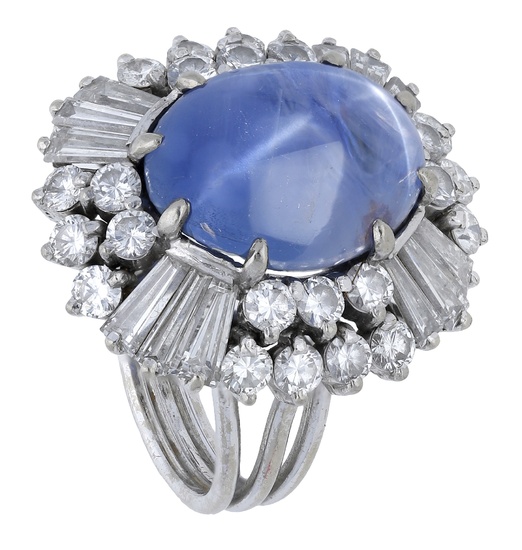 A star sapphire and diamond cluster ring, the sapphire cabochon set within...