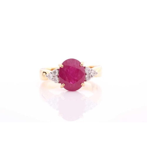 A yellow metal, diamond, and ruby ring, set with a mixed ova...