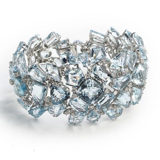 An aquamarine and diamond bracelet set with numerous fancy-cut aquamarines and brilliant-cut diamonds, mounted in 18k white gold. Circa 1950–60.
