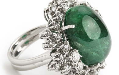 An emerald and diamond ring set with a cabochon emerald weighing app. 23.00 ct. and brilliant-cut diamonds weighing app. 1.50 ct., mounted in 18k white gold.