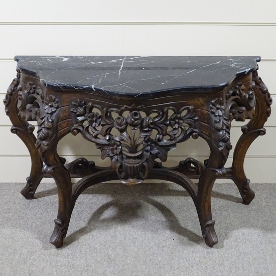 An ornate Rococo style carved walnut console table with shap...