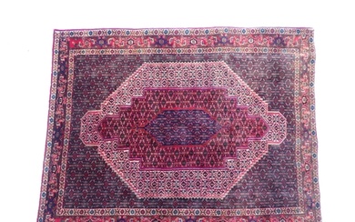 Carpet / Rug: A North West Persian Senneh rug, the red, blue...