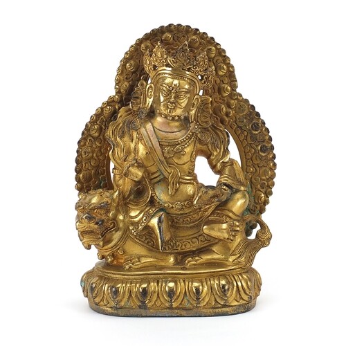 Chino Tibetan gilt bronze figure of a deity on mythical anim...