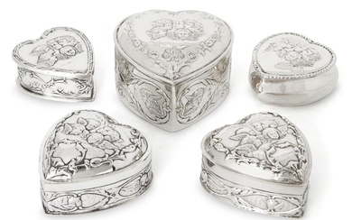 Five heart-shaped Victorian and Edwardian silver trinket boxes variously decorated with putti, the largest example Chester, 1897, James Deakin & Sons, 8.2 x 8.6 x 5cm, together with two similarly designed boxes, one London, 1897 and 1904, William...