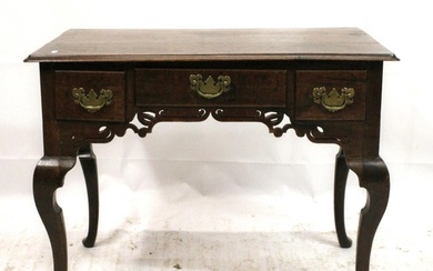 George III oak lowboy, the moulded rectangular top over thre...