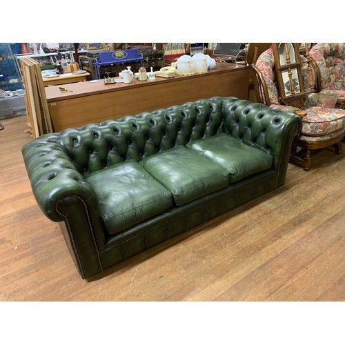 Green leather Chesterfield 3 seater sofa. (small cut in fabr...