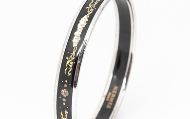 SOLD. Hermès: A bangle made of metal and white, black and yellow enamel with motive in the shape of stars and clouds. W. 1 cm. Diam. app. 6.2 cm. – Bruun Rasmussen Auctioneers of Fine Art