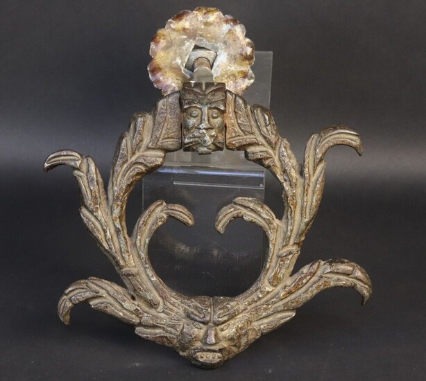 Wrought iron knocker. Leafy ring, striker and axis front decorated with grimacing faces. 18th century. Height 17,9 cm