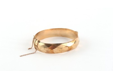 Property of a lady - a 9ct gold hinged bangle, with faceted ...