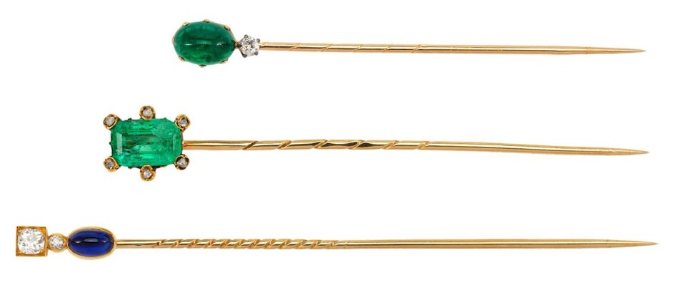 Three Russian, late 19th century diamond and gem-set stickpins: one set with an oval cabochon sapphire and two old-cut diamonds; one with an oval cabochon emerald and one old-cut diamond and one with a cushion shaped emerald the claws accented with...