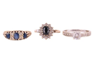Three gem-set rings comprising a sapphire and diamond-set half-hoop ring in 9ct yellow gold, size T