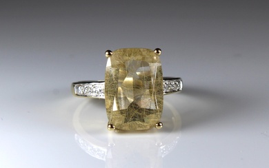 A 9ct yellow gold ring set yellow quartz and diamond shoulders