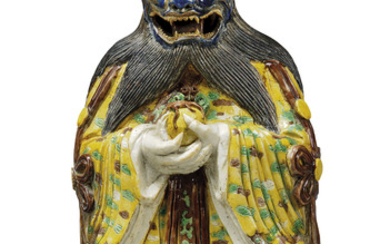 A CHINESE INCISED BISCUIT-ENAMELLED FIGURE OF A DEMON, KANGXI PERIOD (1662-1722)