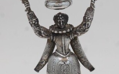 A Continental silver oil lamp, later converted to electricity, stamped 925 and with import marks, 1912, Berthold Hermann Muller, modelled as a 16th century lady with large ruff and foliate engraved dress holding a bowl aloft, on three bun, with...