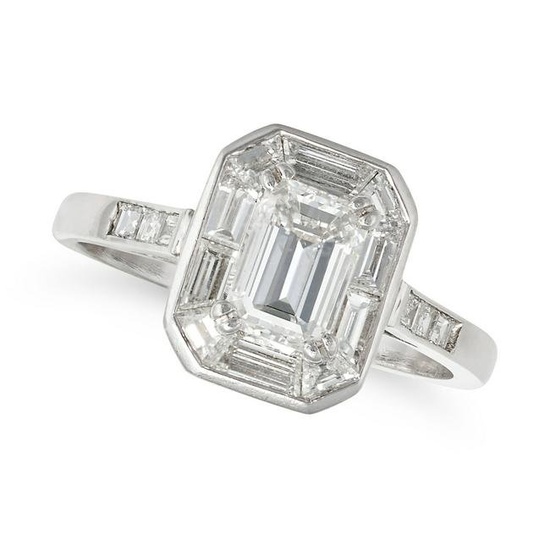A DIAMOND DRESS RING in platinum, set with an emerald cut diamond of 0.72 carats in a border of