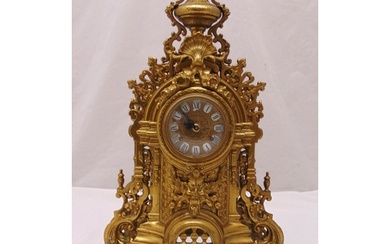 A French late 19th century gilt metal mantle clock, scroll p...