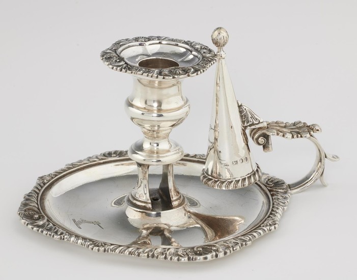 A GEORGE III GADROONED SILVER CHAMBER CANDLESTICK AND EXTING...