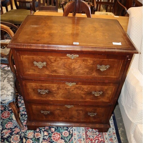 A George III style banded walnut chest of three long drawers...