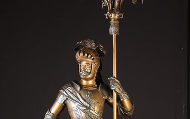 A Large Bronzed Spelter Figural Candelabra cast in the form of a medieval knight in armour with plum