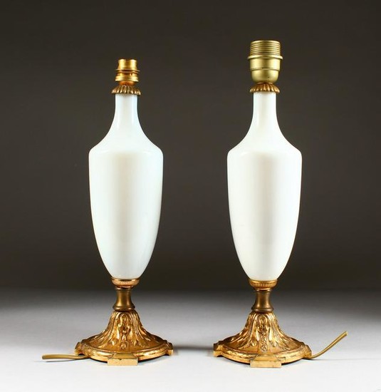A PAIR OF 19TH CENTURY WHITE GLASS TABLE LAMPS. 15ins