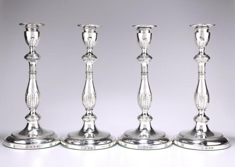 A SET OF FOUR GEORGE III SILVER CANDLESTICKS, by John